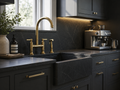 Traditional unlacquered brass bridge faucet with black farmhouse sink