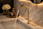 Gold faucet with water flowing into a sink in a bathroom setting.