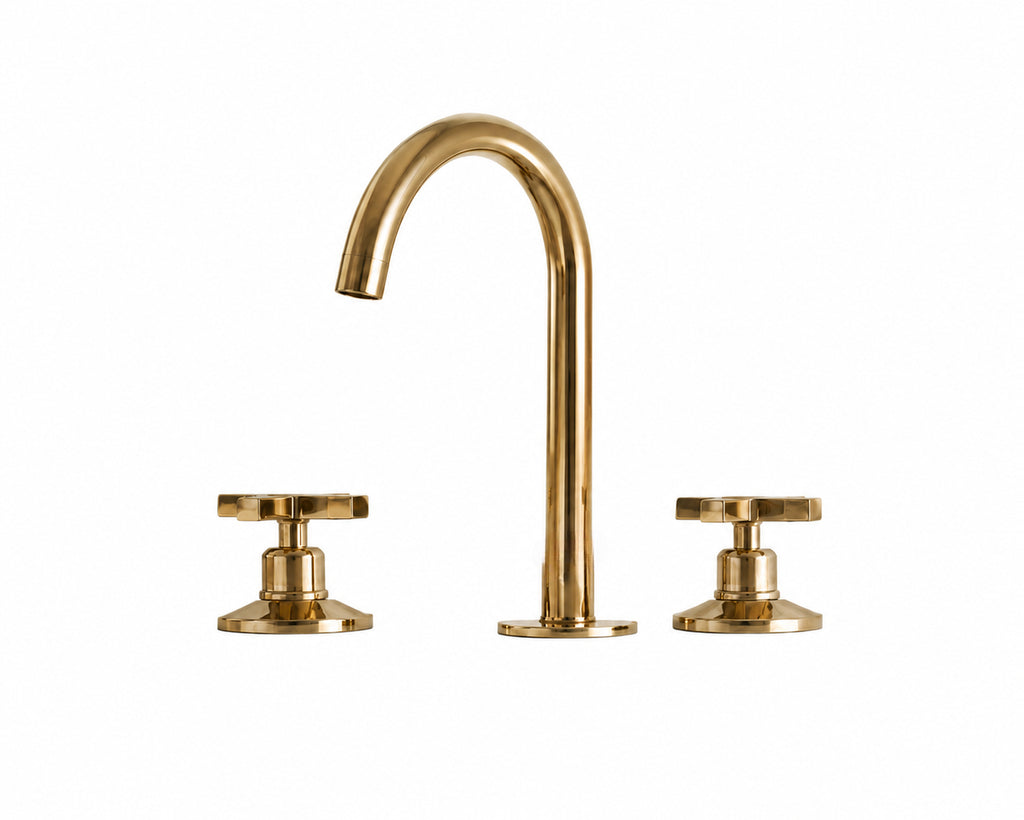 Gold brass bathroom faucet on white background
