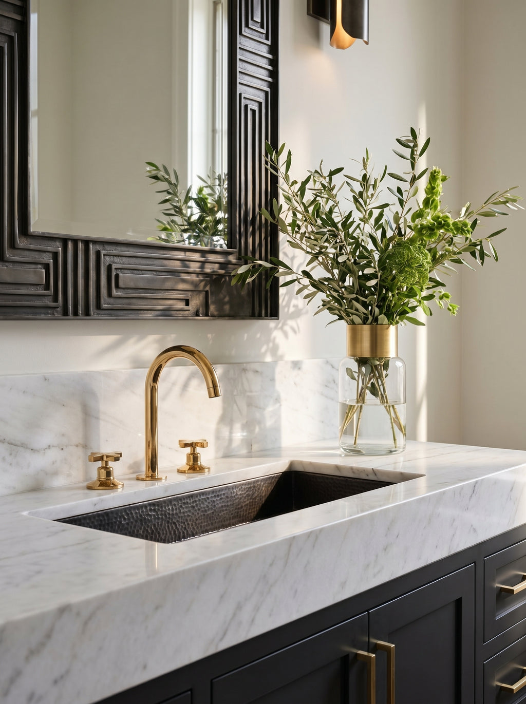 Gold faucet installed on modern marble sink