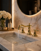 Luxurious bathroom sink with gold faucet and marble countertop