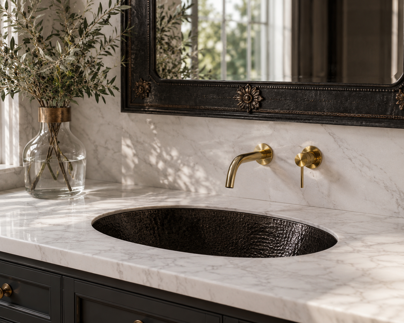 Bathroom vanity with marble countertop, black sink, and gold faucet.