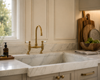 Kitchen sink with gold faucet and marble countertop