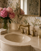Bathroom sink with gold faucet and floral wallpaper