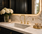 Luxurious bathroom sink setup with gold fixtures, marble countertop, and decorative elements.