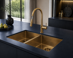 Gold kitchen sink and faucet set against a dark countertop with decorative elements.