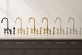 Collection of various kitchen faucets on a neutral background with labels indicating color options.