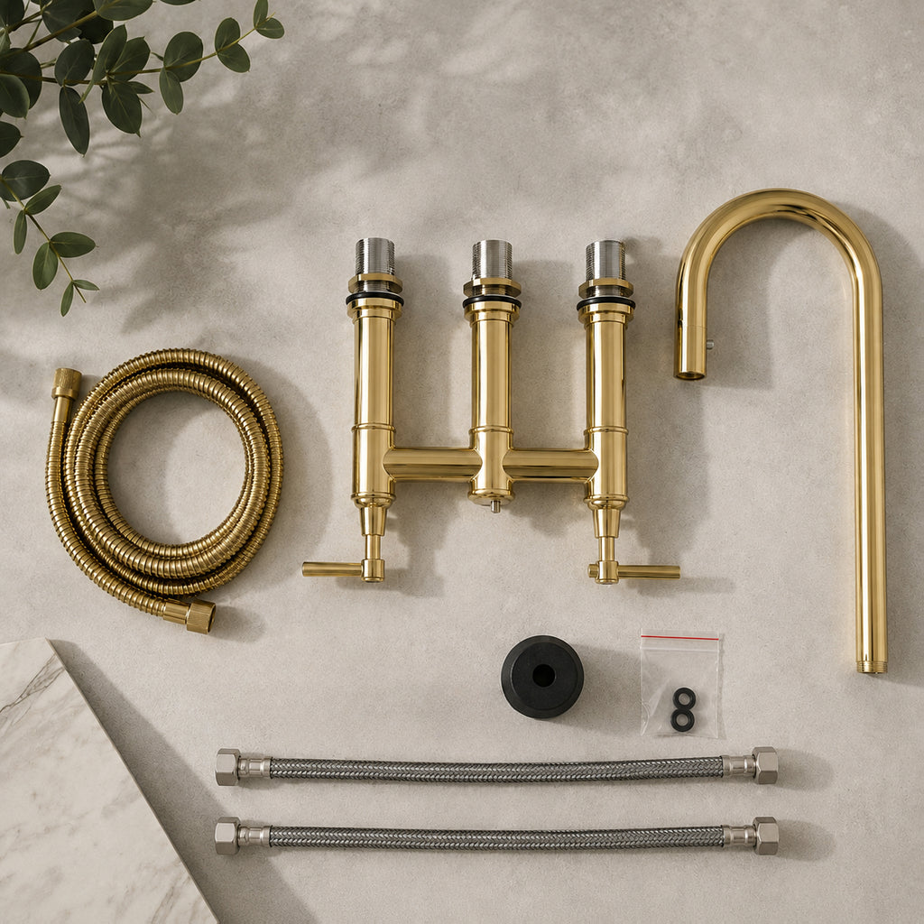Gold kitchen faucet set with hoses and connectors on a neutral background